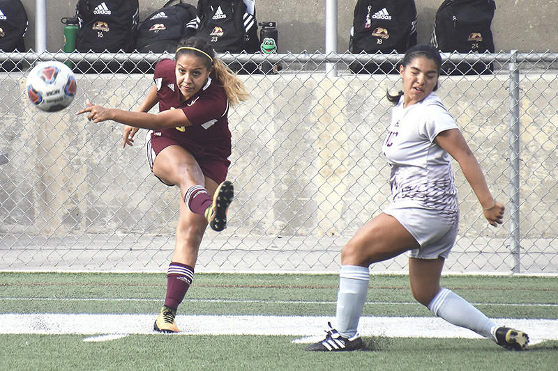 Lady JAG Veronica Romero kicks ball to teammate